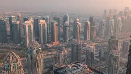 JLT skyscrapers near Sheikh Zayed Road aerial timelapse. Residential buildings and villas behind