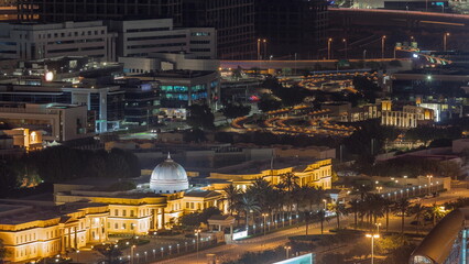 Fototapeta na wymiar Dubai Internet city with the main entrance to the campus of American University in Dubai night timelapse.