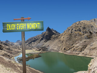 Enjoy Every Moment sign on nature background.