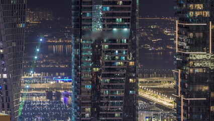 Canal in Dubai Marina with luxury skyscrapers around night timelapse, United Arab Emirates