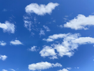 White, fluffy clouds in blue sky. Background from clouds. Beauty clear cloudy in sunshine.