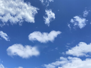 White, fluffy clouds in blue sky. Background from clouds. Beauty clear cloudy in sunshine.