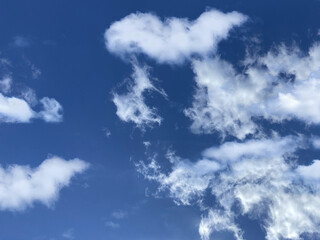 Naklejka na ściany i meble White, fluffy clouds in blue sky. Background from clouds. Beauty clear cloudy in sunshine.