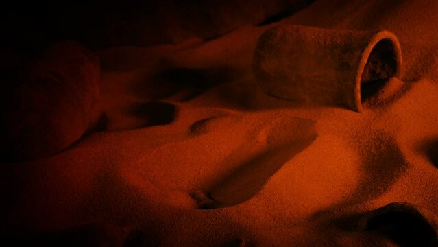 Stone Jar Is Picked Up From Cave Floor In Firelight
