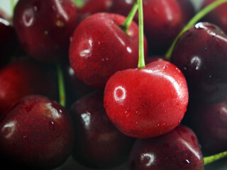 many red cheries berries in  plate background