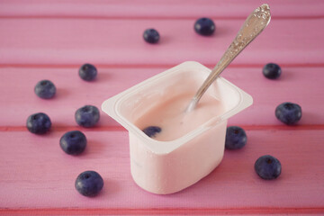 fresh tasty yogurt  and blueberries on wooden background. Healthy Breakfast Concept