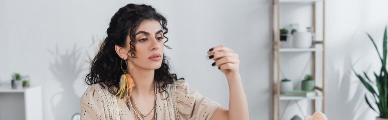 Gypsy medium holding magic crystal at home, banner.