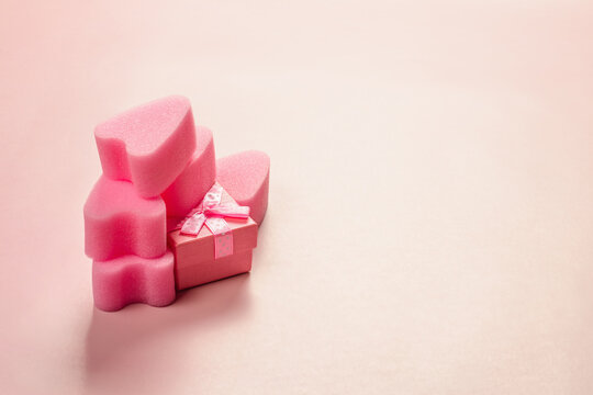 Pink tampons stringless with gift box on pink background. Womens hygiene. Occupation sports and love.