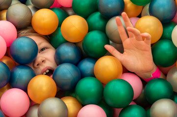 girl in a dry pool with balls