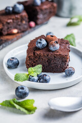 Stack of brownies on black background. Delicious homemade chocolate dessert