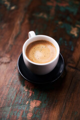 Cup of coffee on rustic wooden background. Copy space.