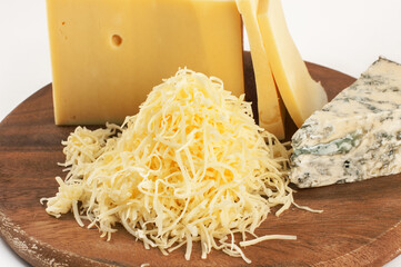 Garganzola cheese and freshly grated parmesan cheese on a wooden table.