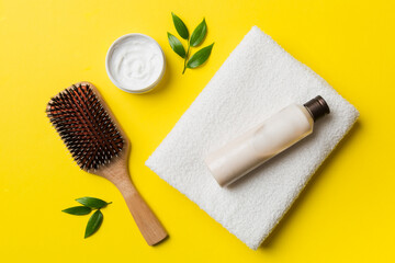 cosmetic for hair care, cream and towel on a colored background top view. flat lay