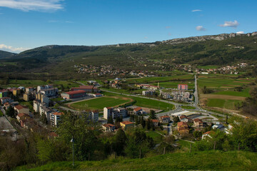 Fototapeta na wymiar The view from the wall of Buzet old town looking down on part of the new town and the surrounding countryside. Istria, Croatia 