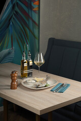 Served table with hot fish dish in restaurant