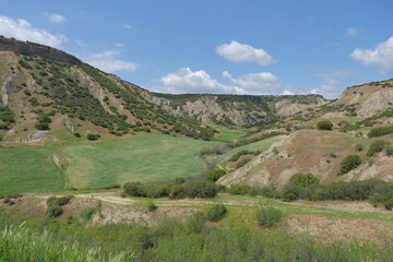 Fototapeta premium Beautiful valley green at springtime, agricultural field and beautiful clouds and sky