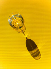 a glass of water on a yellow background