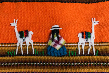 seated peasant woman accompanied by two llamas in a multicolored table embroidered by hand with...