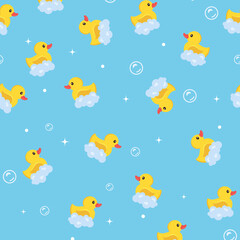 Іeamless pattern. Yellow rubber ducks with foam on a blue background. children's background