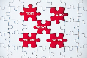 Top view of text on missing jigsaw puzzle - Why, who, what, where and when. Business solution...