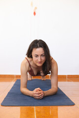 Woman doing yoga at home, abdominal muscle exercise