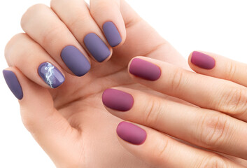 Beautiful purple burgundy matte manicure on white background.
