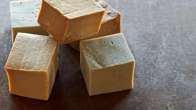 Cubes of natural Aleppo soap in pile. Table spin.