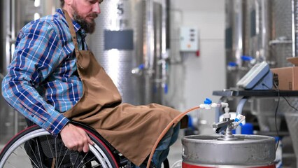 Person with disability who uses a wheelchair working at craft beer factory. High quality 4k footage - Powered by Adobe