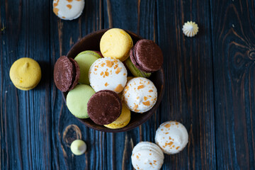 multi-colored macaroon on a wooden background