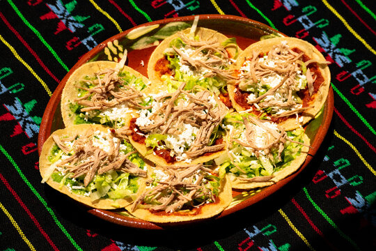 Typical Mexican dish made with tortillas, sauce, cheese, meat and lettuce, known as Chalupas Mexicanas. Mexican food