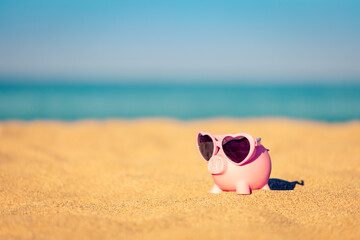 Piggybank on the beach in summer