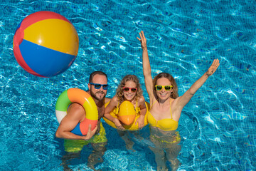 Happy family in outdoor pool