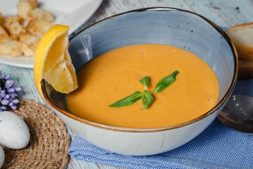 Lentil soup in a blue dish with lemon. Top view