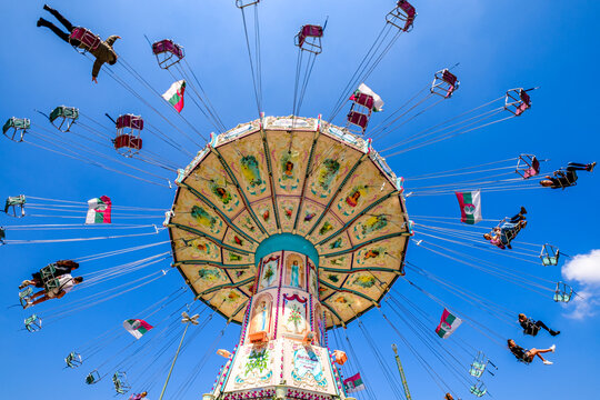 Munich, Germany - May 3: typical rides, ferries wheel, rollercoaster at the annual spring festival (frühlingsfest) in munich on May 3, 2022