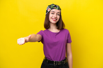 Young Ukrainian woman isolated on yellow background giving a thumbs up gesture