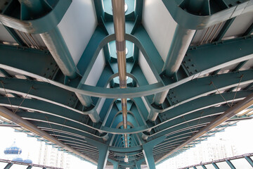 View of the metal roof structures of the light metro station on a clear sunny day. Transport railway technology.