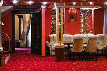 luxury premium restaurant. restaurant interior in red and yellow colors. columns in the restaurant....