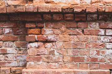 Ancient brick masonry made of red clay bricks with white salt protruding. Background