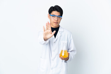 Young Chinese scientific man isolated on white background making stop gesture