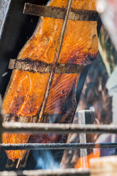 Smoked salmon fillet on a wooden boards prepared on open fire