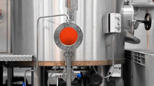 large steel tanks with beer in industrial brewery plant. Stainless steel tanks for brewing beer. automatized process. Modern Beer Factory. Brewery concept. Brewing equipment. High quality 4k footage