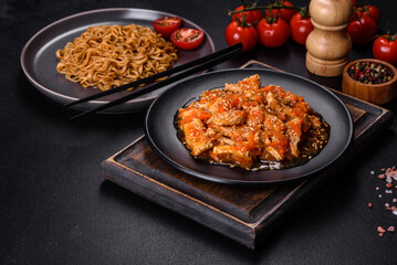 Thai noodle and chicken plate on a black concrete background with Chinese chopsticks and copy space