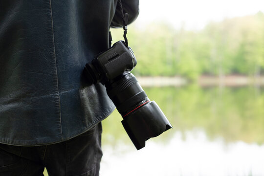 man hand with camera in nature