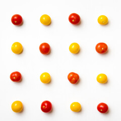 Red and yellow cherry tomatoes pattern on white background. Flat lay. Top view.