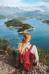Fototapeta na wymiar Woman backpacker enjoying lake view alone outdoor Travel adventure in Turkey active vacations healthy lifestyle eco tourism girl sitting on cliff