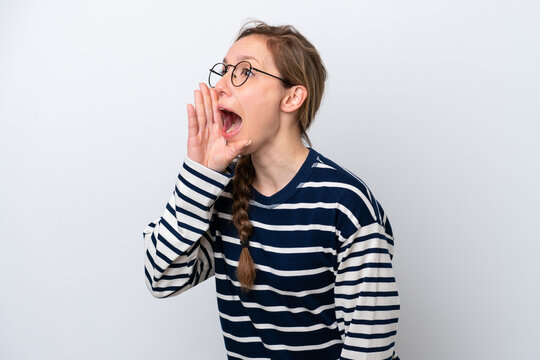 Young caucasian woman isolated on white background shouting with mouth wide open to the side
