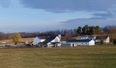 Fototapeta na wymiar Large Amish Farm on a Hillside Among Pasture