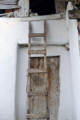 Fototapeta na wymiar classic handmade wooden ladder for climbing on the roof,