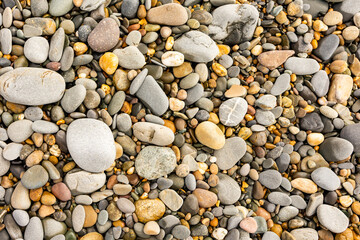 from above close up of beach pebbles and stones