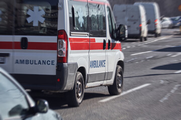 Paramedic 911 ambulance car running fast through the big city.